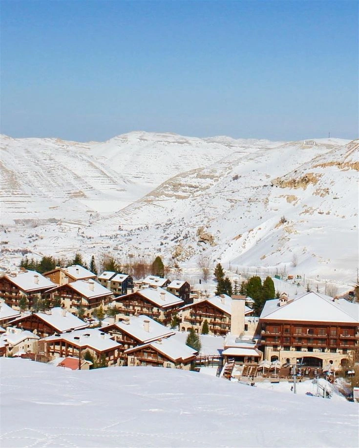 Snow-covered chalets and ski slopes at Mzaar Ski Resort in Kfardebian Lebanon